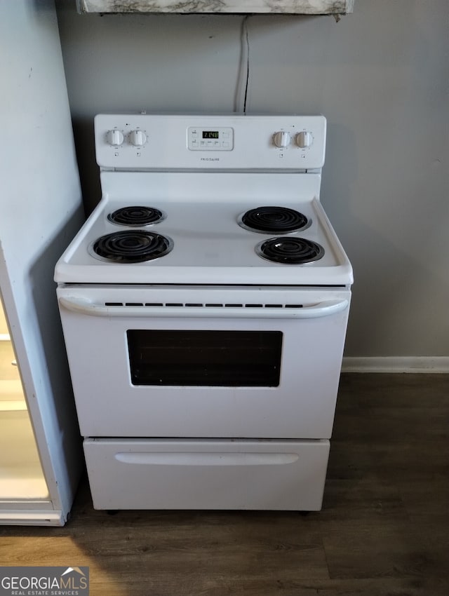 kitchen with electric range and dark hardwood / wood-style flooring