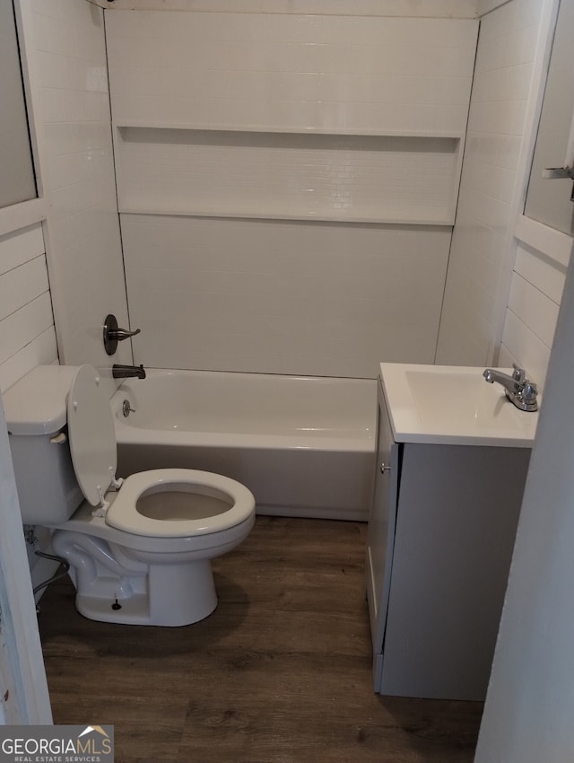 full bathroom with hardwood / wood-style floors, vanity, bathtub / shower combination, and toilet