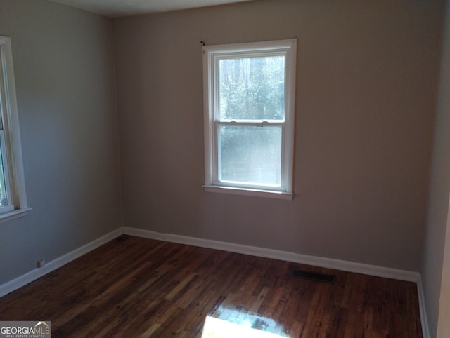 unfurnished room featuring dark hardwood / wood-style flooring