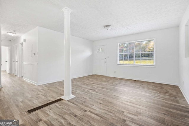 interior space featuring a textured ceiling and light hardwood / wood-style flooring