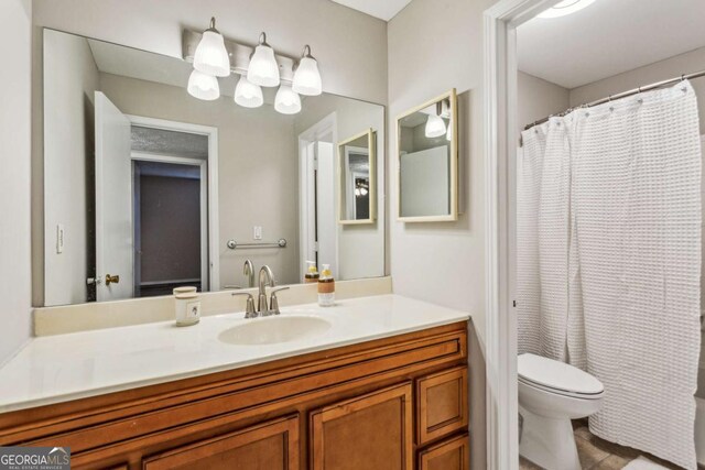 bathroom featuring vanity and toilet