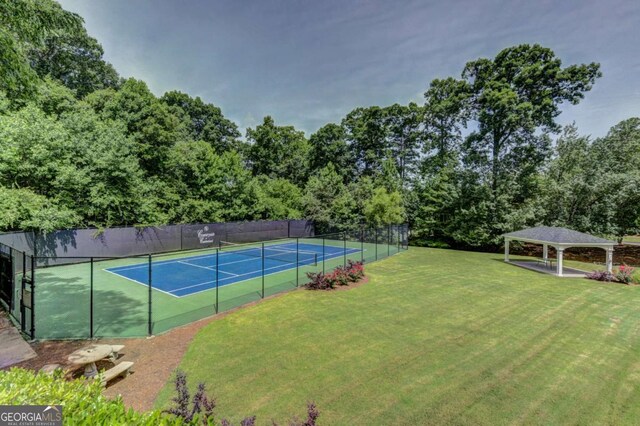 view of tennis court featuring a gazebo and a yard