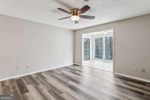 unfurnished room with wood-type flooring, a textured ceiling, and ceiling fan