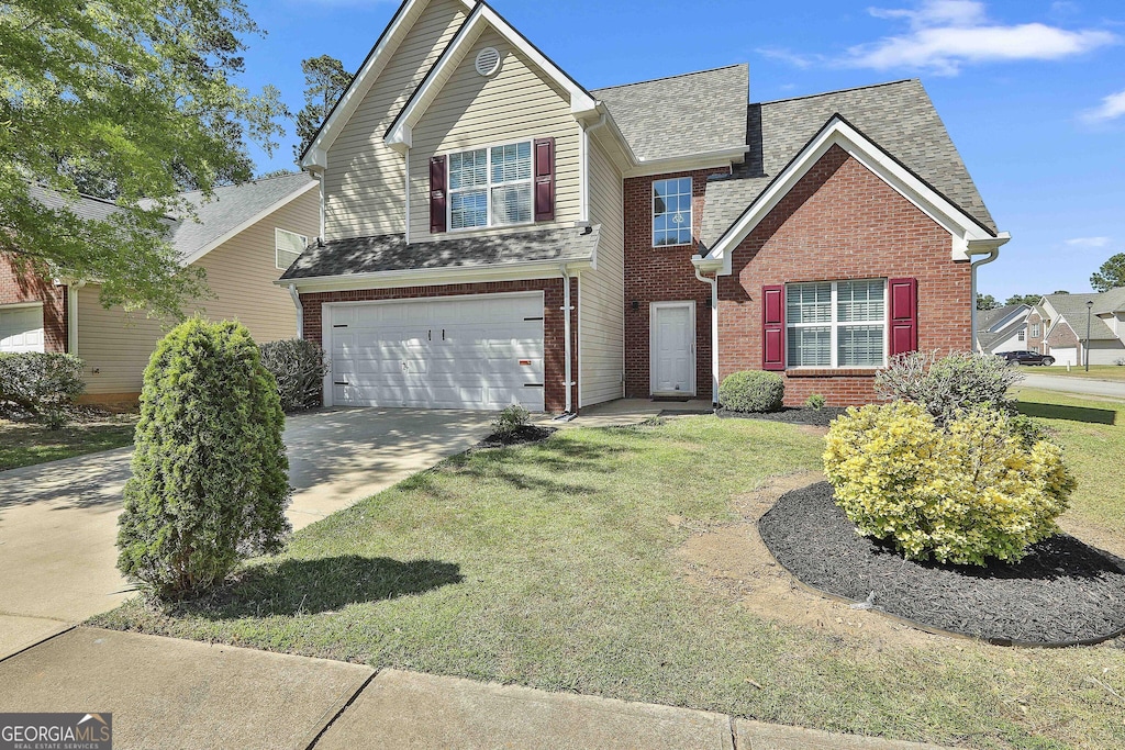 view of front property with a garage and a front lawn