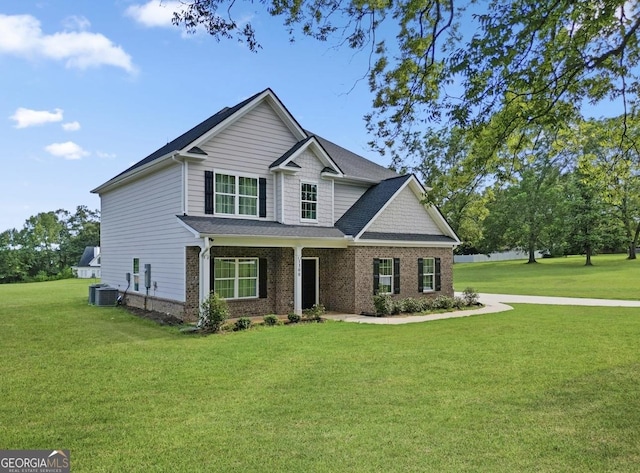 craftsman-style home featuring central AC unit and a front lawn