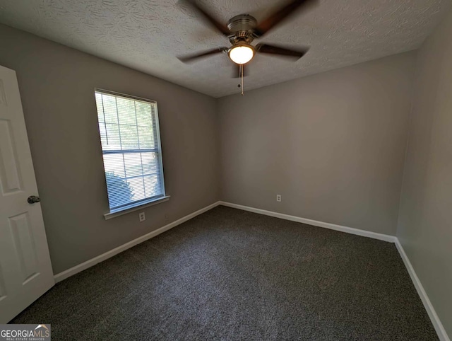 carpeted spare room with a textured ceiling and ceiling fan