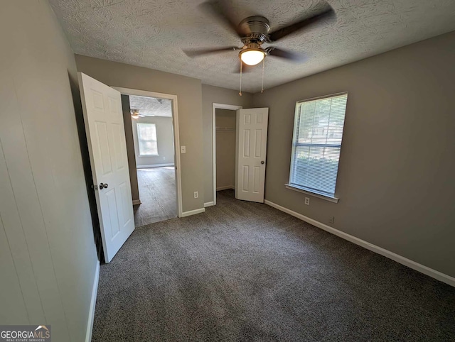 unfurnished bedroom featuring ceiling fan, a textured ceiling, and carpet floors