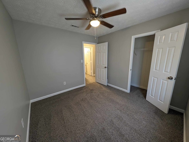 unfurnished bedroom featuring carpet floors, ceiling fan, a closet, and a textured ceiling