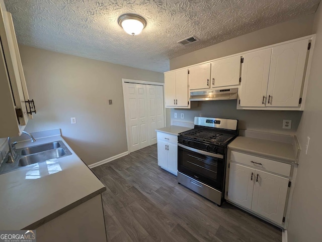 kitchen featuring dark hardwood / wood-style floors, sink, stainless steel range with gas cooktop, white cabinetry, and a textured ceiling