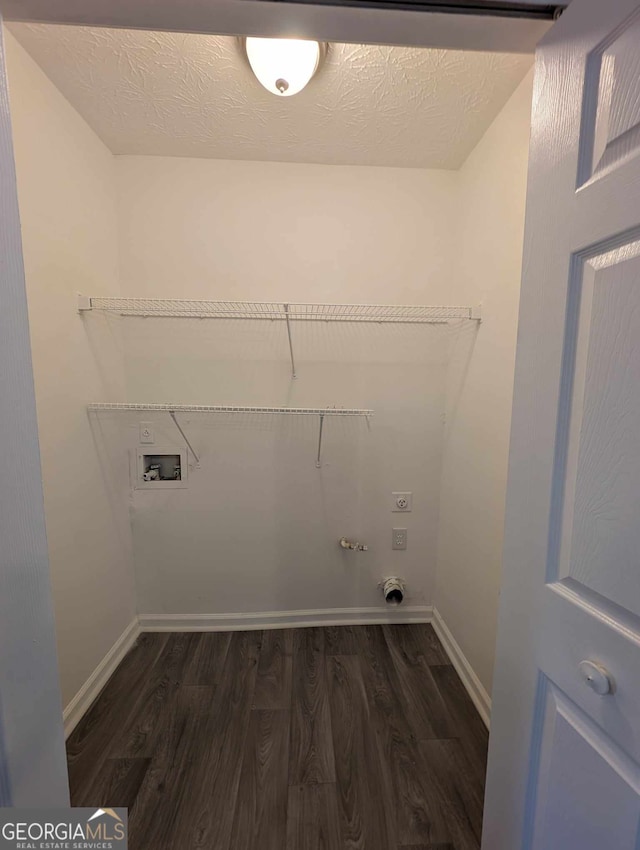 washroom with dark hardwood / wood-style flooring, washer hookup, and hookup for an electric dryer