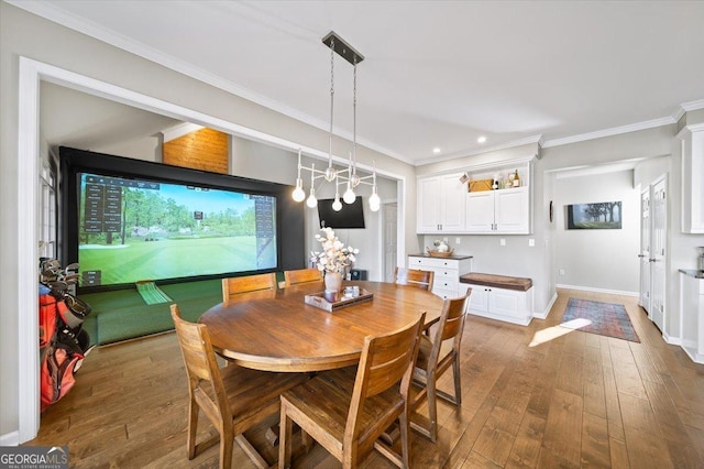 dining space featuring dark hardwood / wood-style floors, golf simulator, and ornamental molding