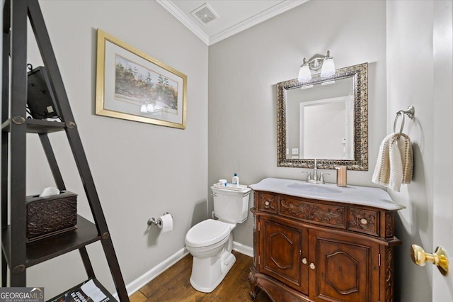 bathroom with hardwood / wood-style flooring, toilet, vanity, and ornamental molding