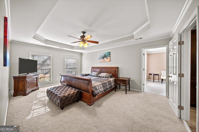 bedroom featuring a raised ceiling, ceiling fan, and light carpet