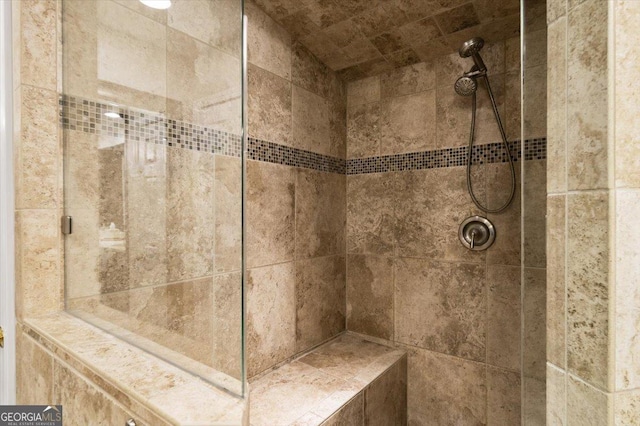 bathroom featuring tiled shower