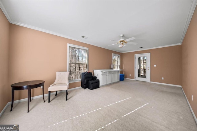 sitting room with light carpet, ceiling fan, and ornamental molding