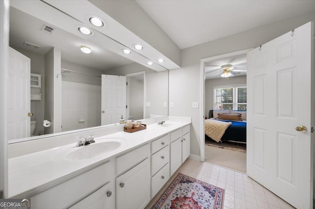 bathroom featuring ceiling fan, toilet, and vanity