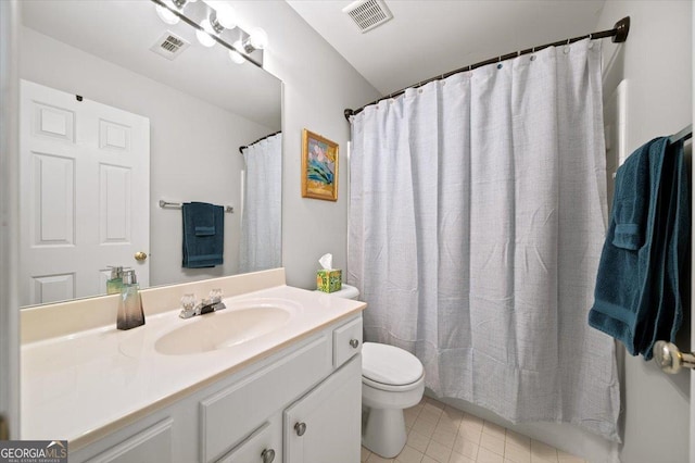 bathroom featuring tile patterned flooring, vanity, toilet, and curtained shower