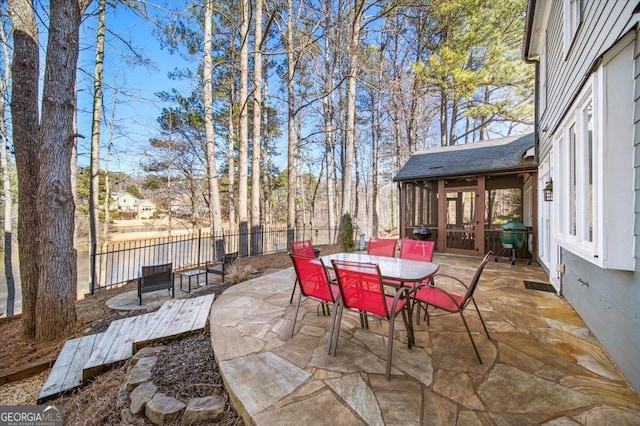 view of patio / terrace with area for grilling and a sunroom