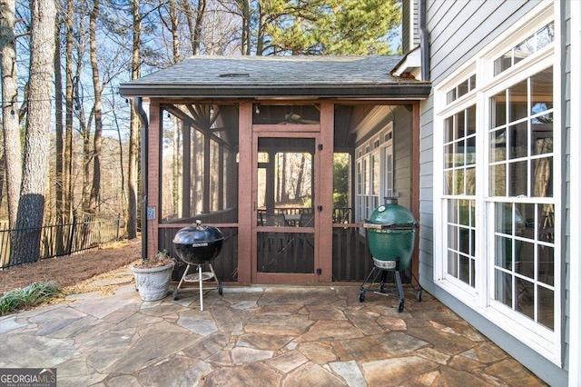 view of patio / terrace featuring grilling area and a sunroom