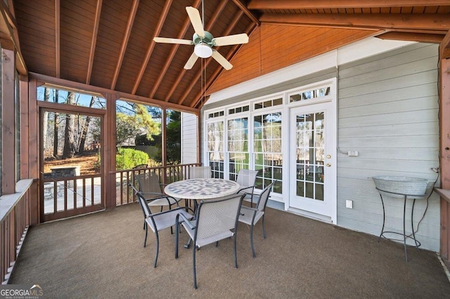 sunroom / solarium featuring vaulted ceiling with beams, ceiling fan, and wooden ceiling