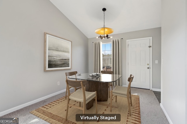 dining room featuring a chandelier, carpet, and vaulted ceiling