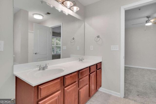 bathroom with vanity and ceiling fan with notable chandelier