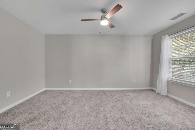 empty room featuring carpet and ceiling fan