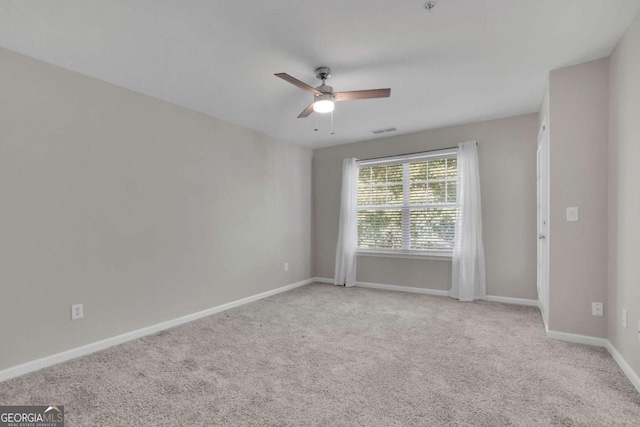 empty room with light carpet and ceiling fan