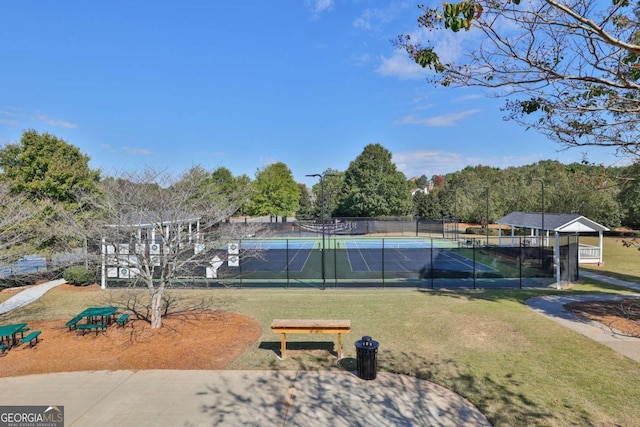 view of community with a lawn and tennis court