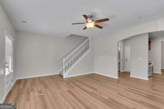 unfurnished living room with ceiling fan and light wood-type flooring