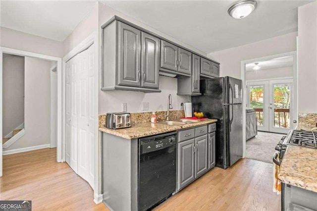 kitchen with black appliances, gray cabinetry, sink, and french doors