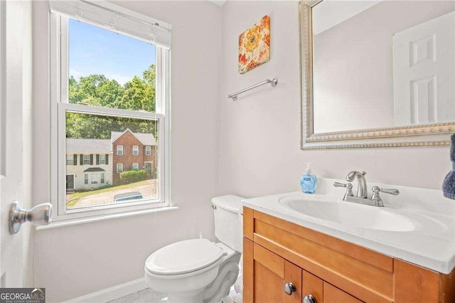 bathroom featuring vanity and toilet