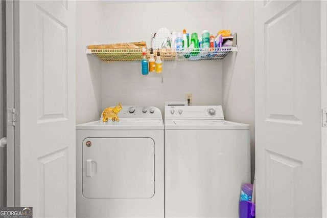 washroom with washing machine and clothes dryer