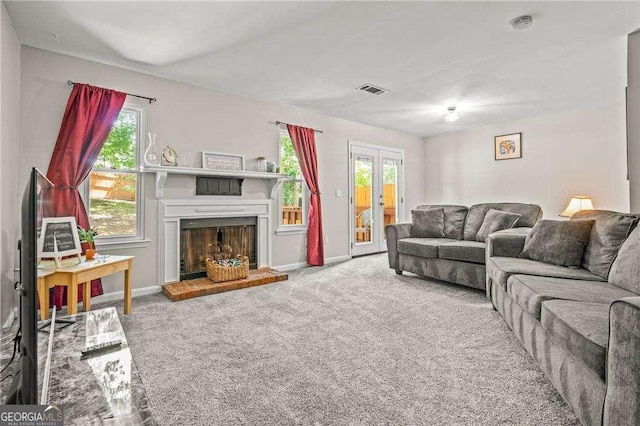 living room with carpet flooring and plenty of natural light