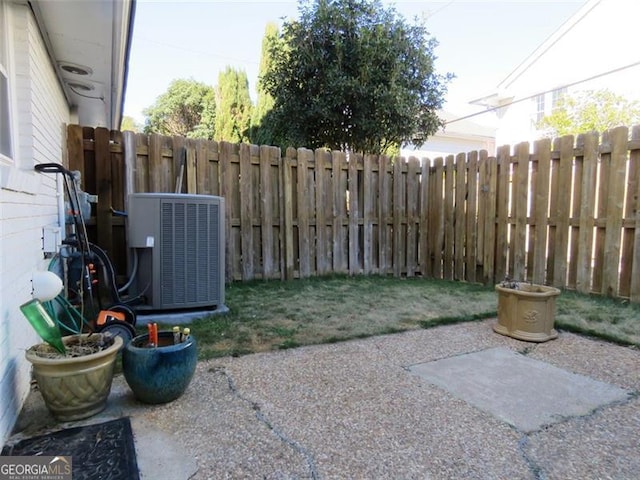 view of yard featuring central AC and a patio