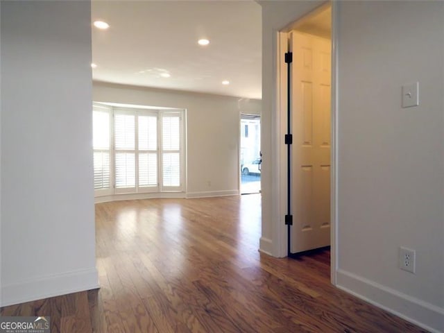 empty room with dark wood-type flooring