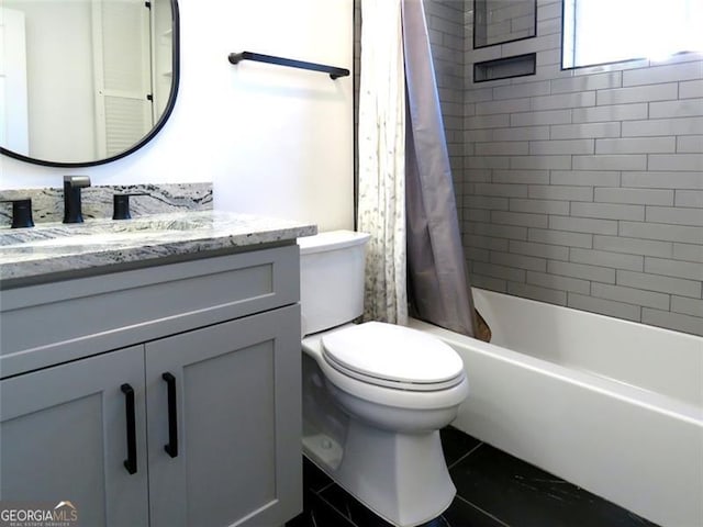 full bathroom featuring shower / bath combination with curtain, vanity, and toilet