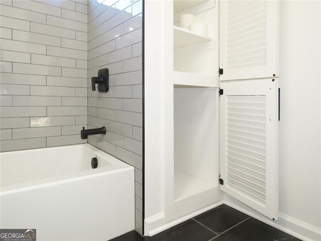 bathroom featuring tile patterned floors and tiled shower / bath combo