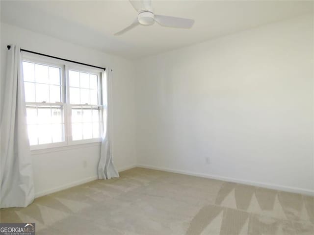 carpeted empty room with ceiling fan