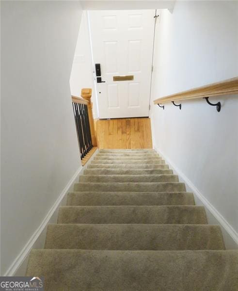 stairs with hardwood / wood-style flooring