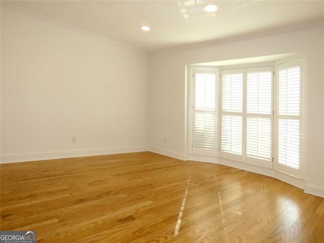 unfurnished room with crown molding and hardwood / wood-style flooring