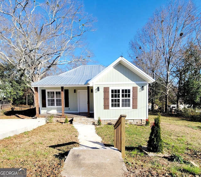 view of front of house with a front yard and a porch