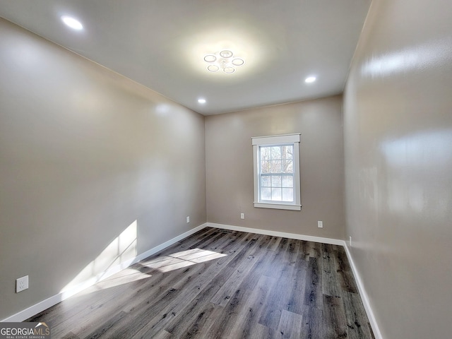 spare room featuring dark hardwood / wood-style floors