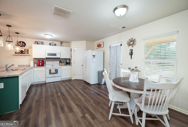 dining room with visible vents, baseboards, and dark wood-style flooring