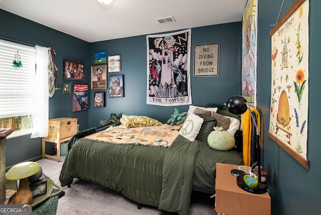 carpeted bedroom featuring visible vents