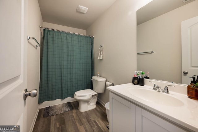bathroom featuring vanity, wood finished floors, visible vents, baseboards, and toilet