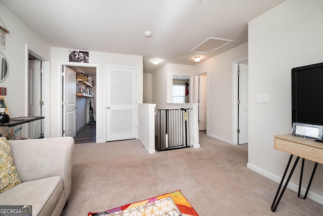 interior space with attic access and baseboards