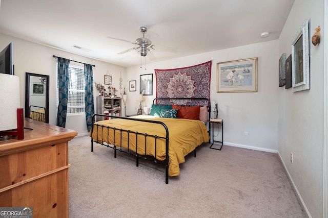 carpeted bedroom with visible vents, ceiling fan, and baseboards