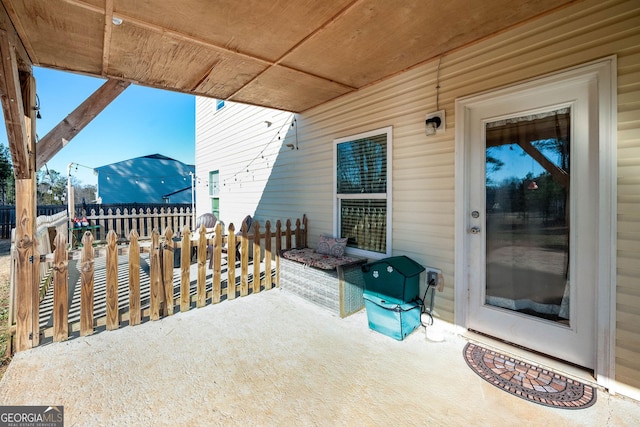 view of patio featuring fence
