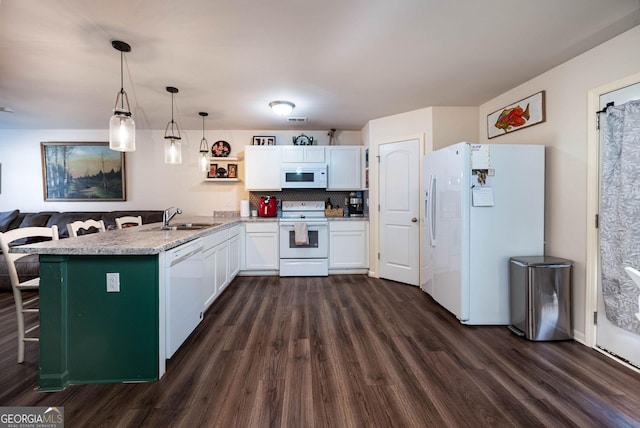 kitchen with a sink, white cabinetry, white appliances, a peninsula, and dark wood-style flooring